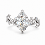 A silver-toned diamond ring featuring a large marquise-cut center stone with smaller diamonds set along a vine-inspired band with leaf and flower motifs, shown on a clean white background.