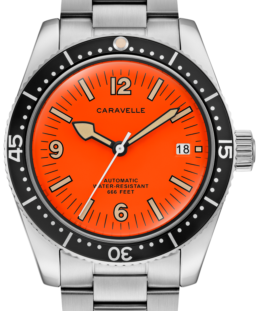 A Caravelle automatic dive watch with a vibrant orange dial, black rotating bezel, and a brushed stainless steel link bracelet.
