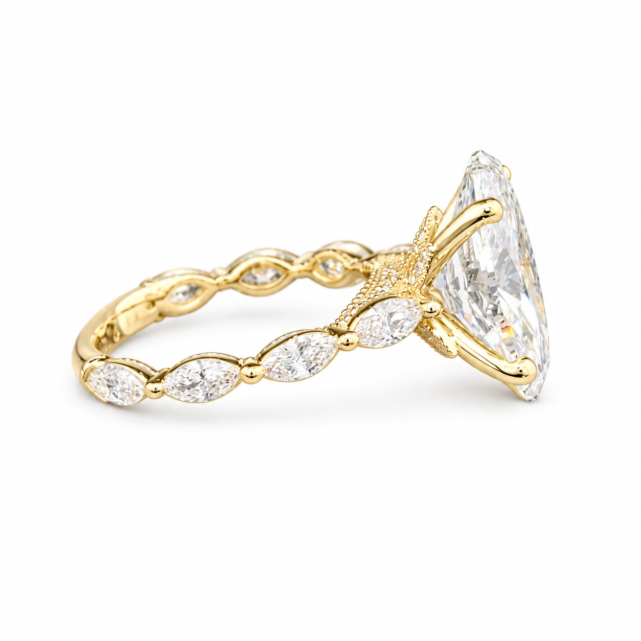 A yellow gold ring featuring a large marquise-cut clear gemstone in a star-shaped setting, with smaller marquise-cut stones along the band, shown on a plain white background.