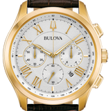 A Bulova watch with a gold-tone case, a white dial with Roman numerals and three subdials, and a dark brown leather strap, shown on a plain white background.