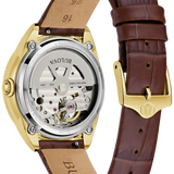 Bulova watch with brown leather strap and gold case on white background