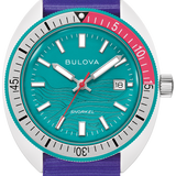 A Bulova Snorkel watch featuring a vibrant purple fabric strap, a turquoise dial with wave patterns, a silver-tone case, and a bezel with a red outer ring.