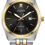 Citizen men's watch with a two-tone silver and gold stainless steel bracelet, a black dial, and gold-tone bezel and hands.