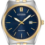 Citizen Eco-Drive watch with a two-tone silver and gold metal bracelet, a stainless steel case, and a deep blue dial with gold accents.