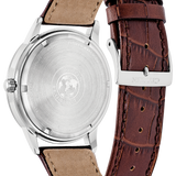 A close-up rear view of a wristwatch with a brown alligator-textured leather strap and a silver stainless steel case back, showing the brand name 'NITRO' on the clasp.