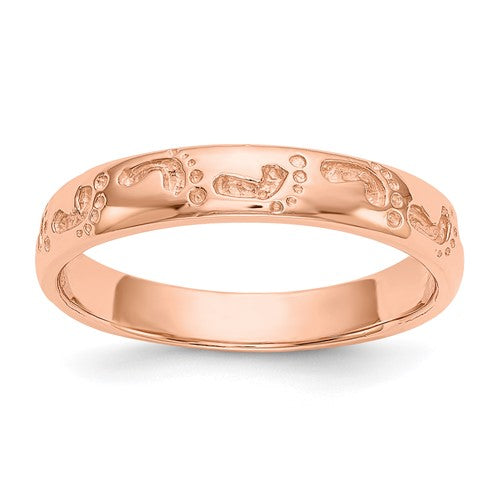 14k rose gold footprints ring from Solomon Jewelers, detailed close-up of delicate jewelry featuring a unique footprints design.