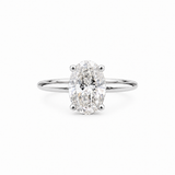 An oval-cut diamond engagement ring with a polished silver-colored band, centered on a clean white background.