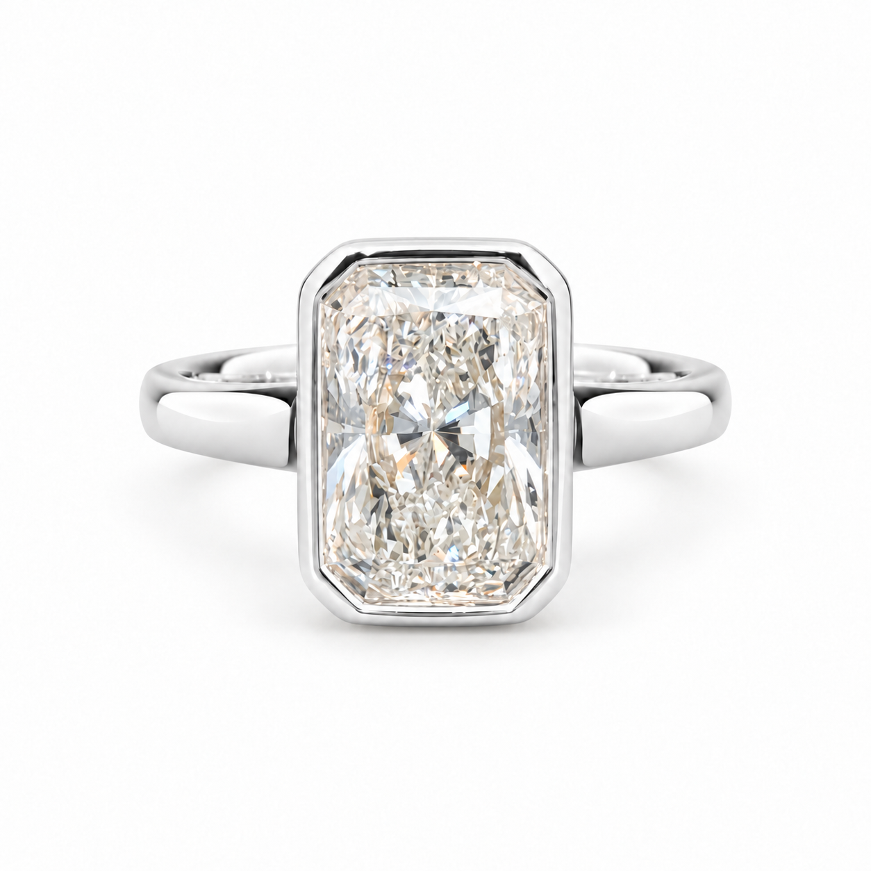 An emerald-cut diamond ring in a silver-toned metal band, centered on a clean white background.