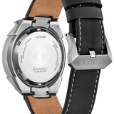 Citizen Eco-Drive watch shown from the back, featuring a brushed stainless steel case, transparent back cover, and a black leather strap with white contrast stitching and a tan interior.