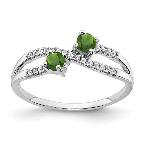 14k white gold two-stone peridot and diamond ring featuring a sleek band and elegant gemstone setting.
