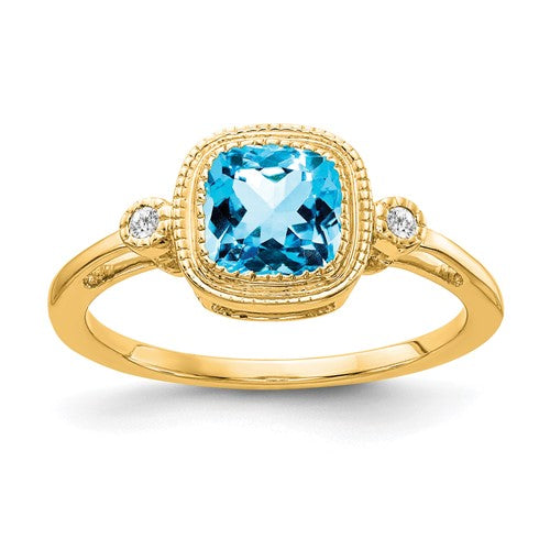 14k gold cushion blue topaz and diamond ring showing the sparkling gemstone and elegant band design