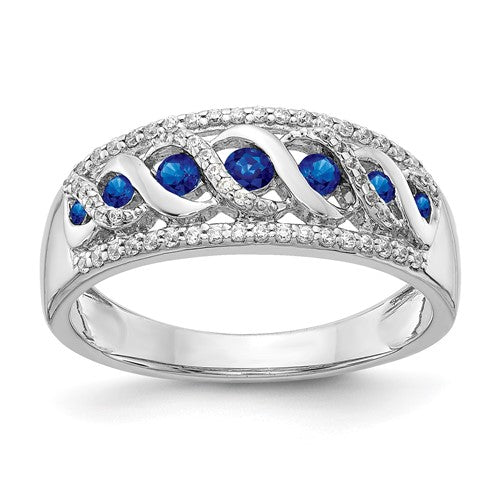 14k white gold diamond and sapphire fancy twist ring featuring intricate design and sparkling gemstones.