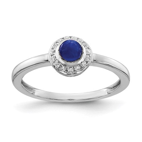14k white gold ring featuring a diamond and cabochon sapphire, showcasing elegant jewelry design with sparkling gemstones.