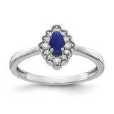 14k white gold ring featuring a diamond and oval cabochon sapphire, elegant jewelry piece with intricate design.