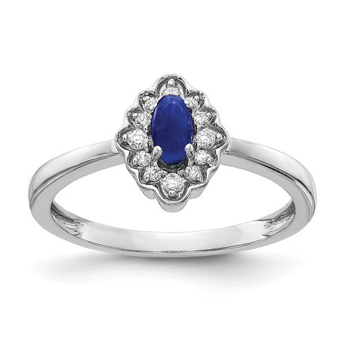 14k white gold ring featuring a diamond and oval cabochon sapphire, elegant jewelry piece with intricate design.