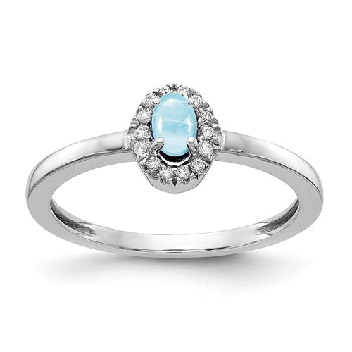 14k white gold ring featuring a large oval cabochon aquamarine and diamond accents, elegant jewelry piece from Solomon Jewelers