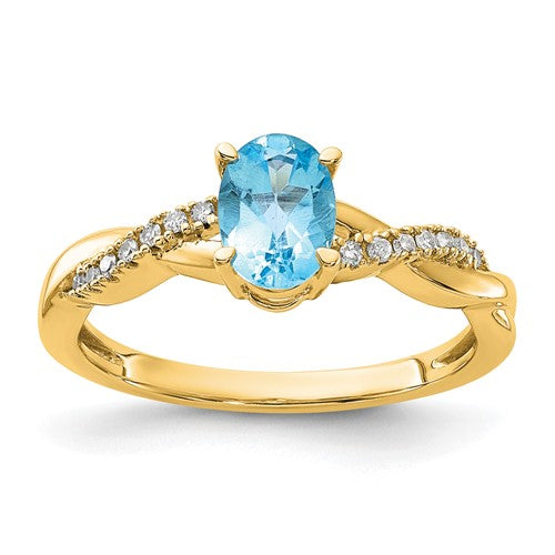 14K gold oval blue topaz and diamond ring with intricate band design by Solomon Jewelers.