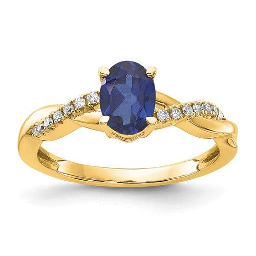 14K gold oval created sapphire and diamond ring with intricate detailing, crafted by Solomon Jewelers.