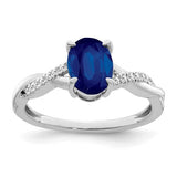 14k white gold oval sapphire and diamond ring with intricate band design, showcasing elegant gemstone arrangement.