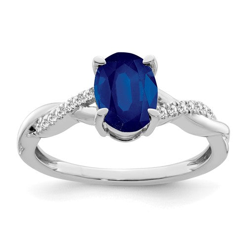 14k white gold oval sapphire and diamond ring with intricate band design, showcasing elegant gemstone arrangement.