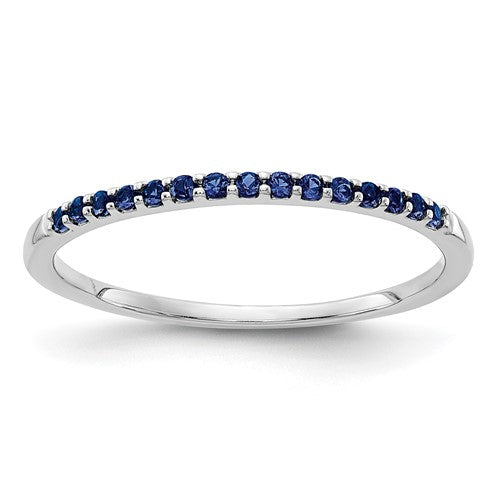14k white gold blue sapphire ring with a band design, featuring a central blue sapphire gemstone, from Solomon Jewelers.