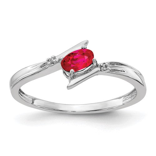 14k white gold oval diamond and ruby bypass ring with polished finish, designed by Solomon Jewelers.