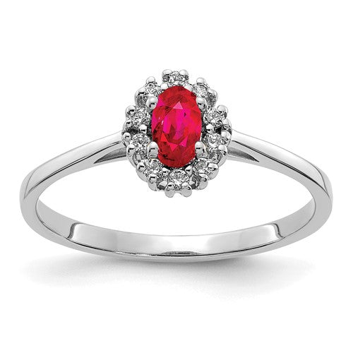 14k white gold diamond and oval ruby halo ring showcasing sparkling diamonds and vibrant ruby centerpiece.