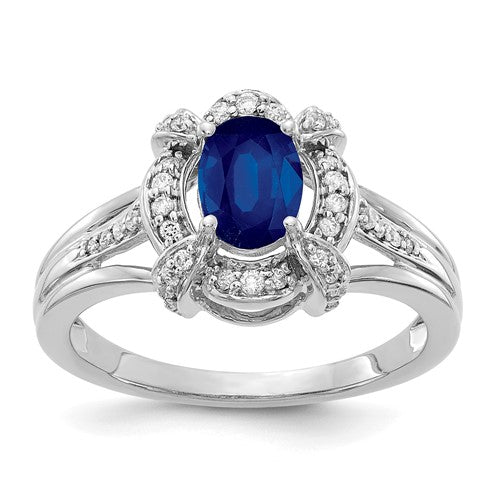 14k white gold ring with a central oval sapphire and diamond accents, elegant jewelry piece from Solomon Jewelers.