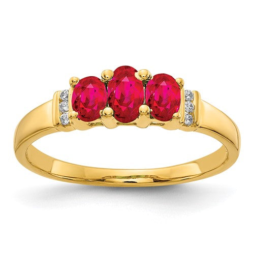 14k polished gold triple ruby and diamond 3-stone ring featuring a central ruby with side diamonds.
