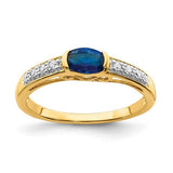 14k gold oval east-west sapphire and diamond ring, showcasing a stunning jewelry piece with intricate design and sparkling gemstones.