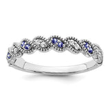 14k white gold Tanzanite and diamond twist ring with intricate design, featuring vibrant blue gemstones and sparkling accents.