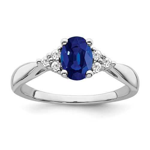 14k white gold ring with a created sapphire centerpiece and diamond accents, elegant jewelry from Solomon Jewelers.
