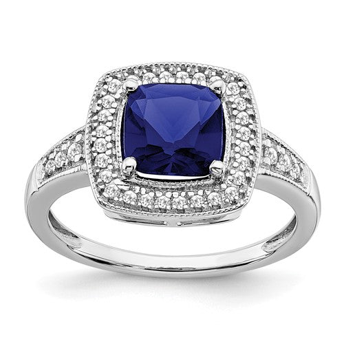 14k white gold cushion sapphire and diamond halo ring with intricate detailing, crafted by Solomon Jewelers.