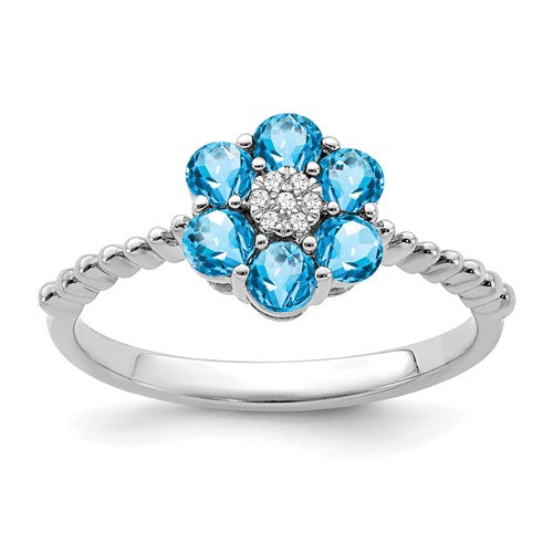14k white gold floral ring featuring blue topaz and diamond accents, elegant jewelry design with intricate detailing.