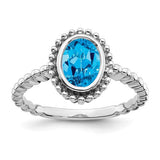 14k white gold oval blue topaz ring with a solitaire gemstone, elegant jewelry piece from Solomon Jewelers.