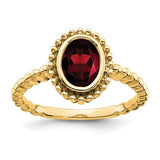 14k oval garnet ring from Solomon Jewelers featuring a vibrant red gemstone in a classic gold setting.