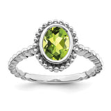 14k white gold oval peridot ring with a polished gemstone setting, elegant jewelry piece from Solomon Jewelers.