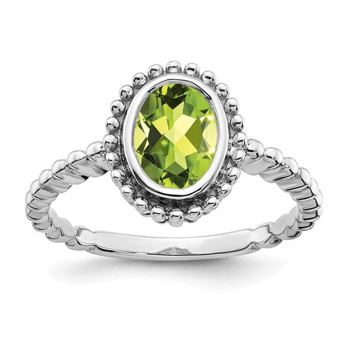 14k white gold oval peridot ring with a polished gemstone setting, elegant jewelry piece from Solomon Jewelers.