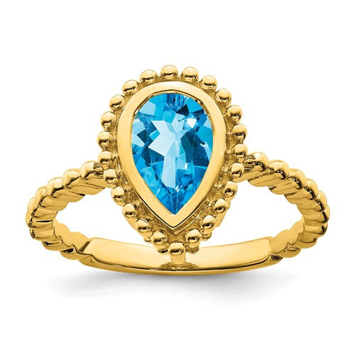 14k gold pear-shaped blue topaz ring featuring a Solomon Jewelers logo and elegant jewelry design.