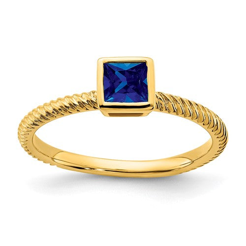 14k gold square bezel sapphire ring with a central blue sapphire, designed by Solomon Jewelers, featuring elegant jewelry craftsmanship.
