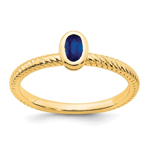14k gold oval bezel sapphire ring featuring a vibrant blue sapphire gemstone set in a sleek Solomon Jewelers jewelry ring.