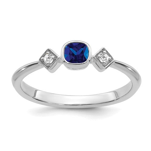 14k white gold sapphire and diamond ring showcasing a central sapphire surrounded by sparkling diamonds, elegant jewelry by Solomon Jewelers