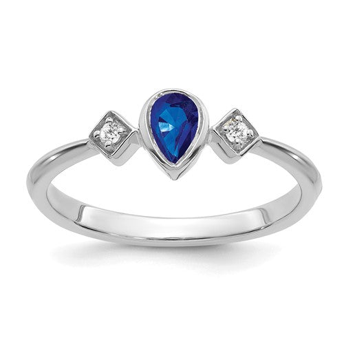 14k white gold ring with pear-shaped bezel sapphire and diamond accents, elegant jewelry piece from Solomon Jewelers