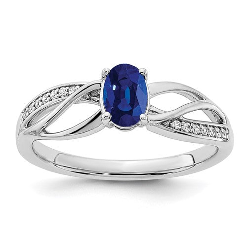 14k yellow gold sapphire and diamond ring with polished finish, featuring a central sapphire stone and surrounding diamonds.