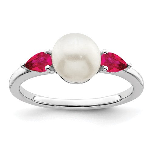 14k white gold pearl and ruby ring featuring a central pearl and ruby accents, elegant jewelry ring by Solomon Jewelers.