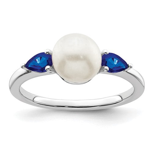 14k white gold pearl and sapphire ring with intricate detailing, featuring a central pearl and blue sapphires from Solomon Jewelers.