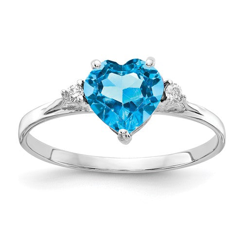 14k white gold ring featuring a 7mm heart-shaped blue topaz centerpiece with diamond accents, crafted by Solomon Jewelers.