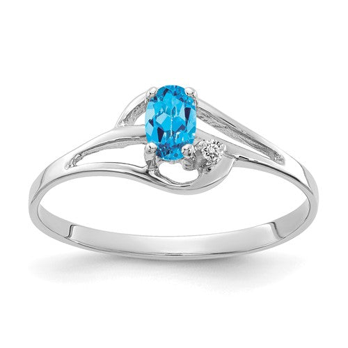 14k white gold blue topaz and diamond ring featuring a large central blue topaz gemstone and sparkling diamonds, elegant jewelry piece