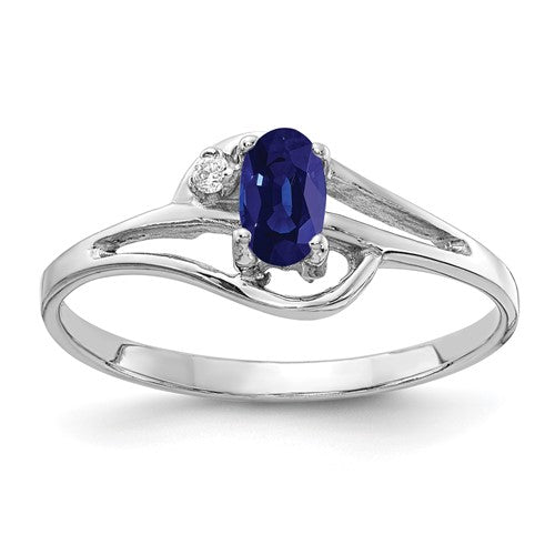 14k white gold sapphire and diamond ring featuring a 5x3mm oval sapphire and AA-grade diamonds, crafted by Solomon Jewelers.