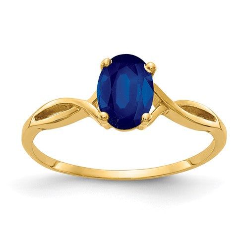 14k gold oval sapphire ring with 7x5mm gemstone, elegant jewelry piece by Solomon Jewelers.